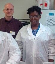 Panayotta Delinois with peers in laboratory