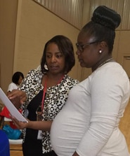 Lisa Moore, Community Health Director for District 1 (left) provides Zika prevention information during the Grenada Health Summit on April 1, 2017.