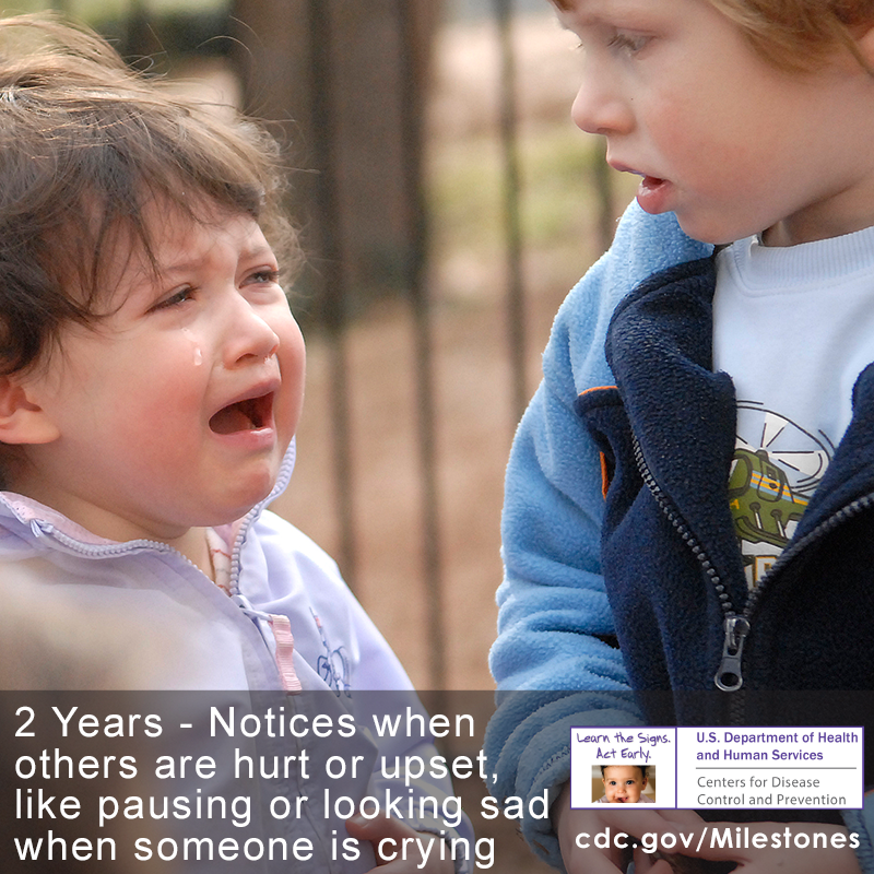 One child in this photo notices when the other child is crying, a 2 year milestone.