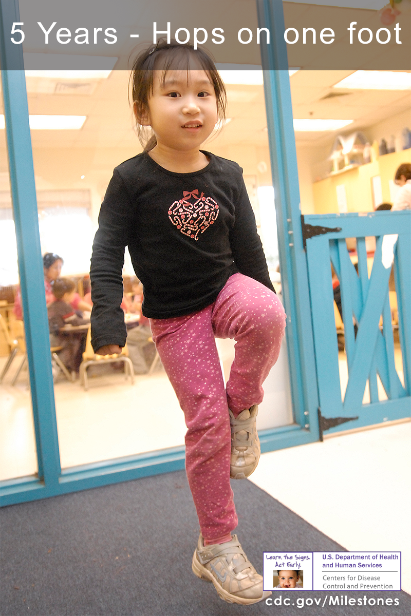 The girl in this photo is hopping on one foot, a 5 year milestone.