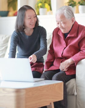 cognitive-decline-3 Younger woman showing elderly woman how to use a laptop computer