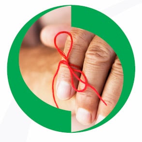 cognitive-decline-header Older adult hand with red string tied around forefinger