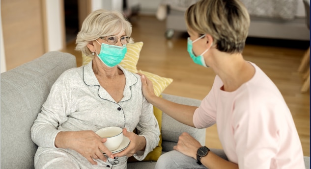Older Woman in Pajamas with Caregiver