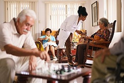 elderly man playing chess in activity room at assisted living center