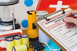 Hand completing Emergency Preparation List by Equipment Hand completing Emergency Preparation List by Equipment