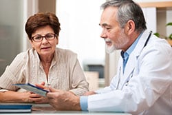 elderly woman consulting with a physician