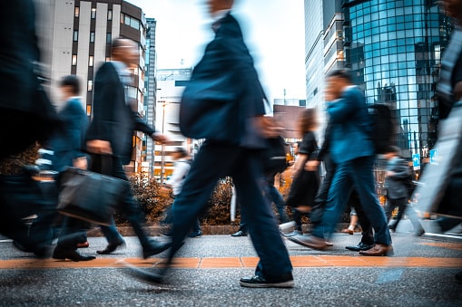 Businesspersons walking in a city.