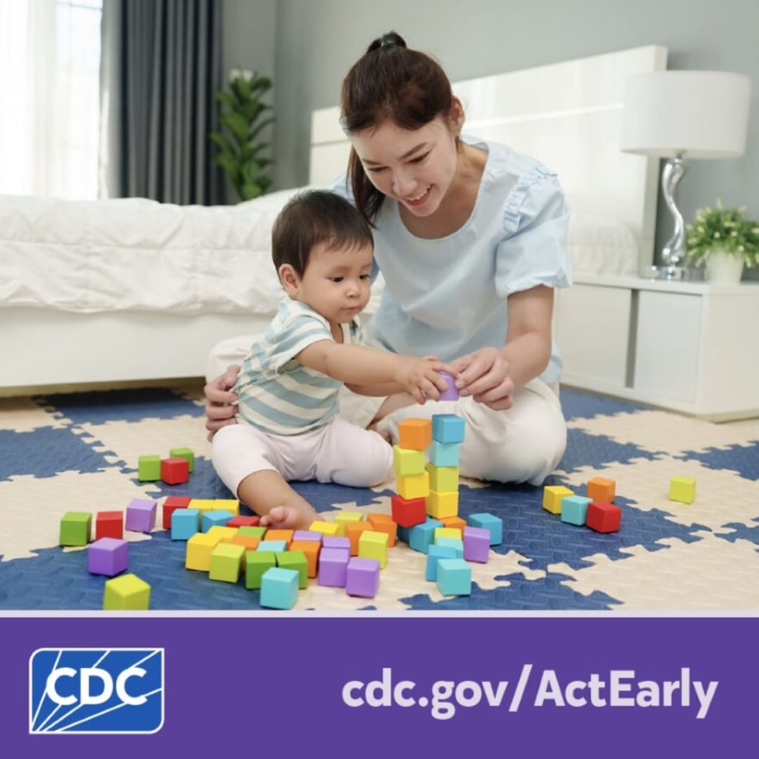 A mother helps her young child play with blocks while sitting on the floor. Text overlay reads, “cdc dot gov slash Act Early.”