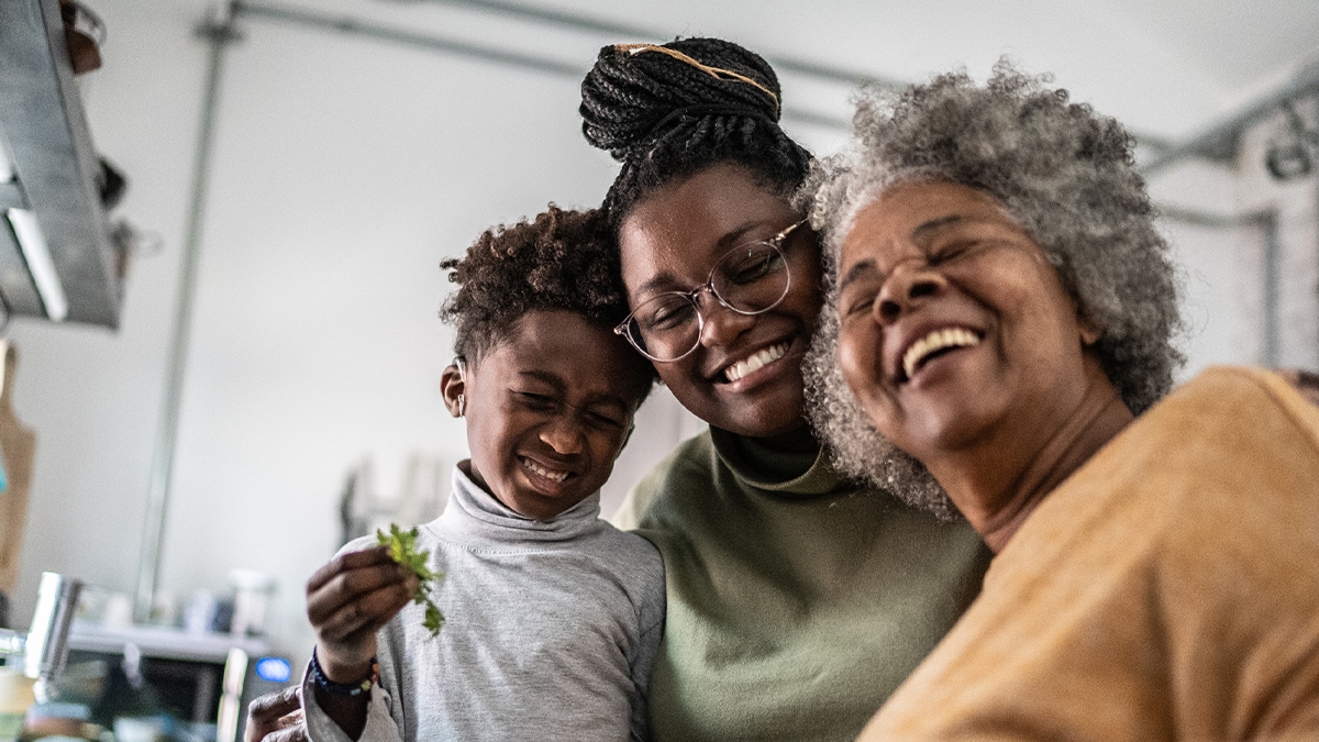 a boy is smiling with his mother and grandmother