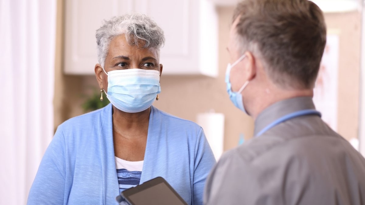 Photo of a nurse talking to a patient