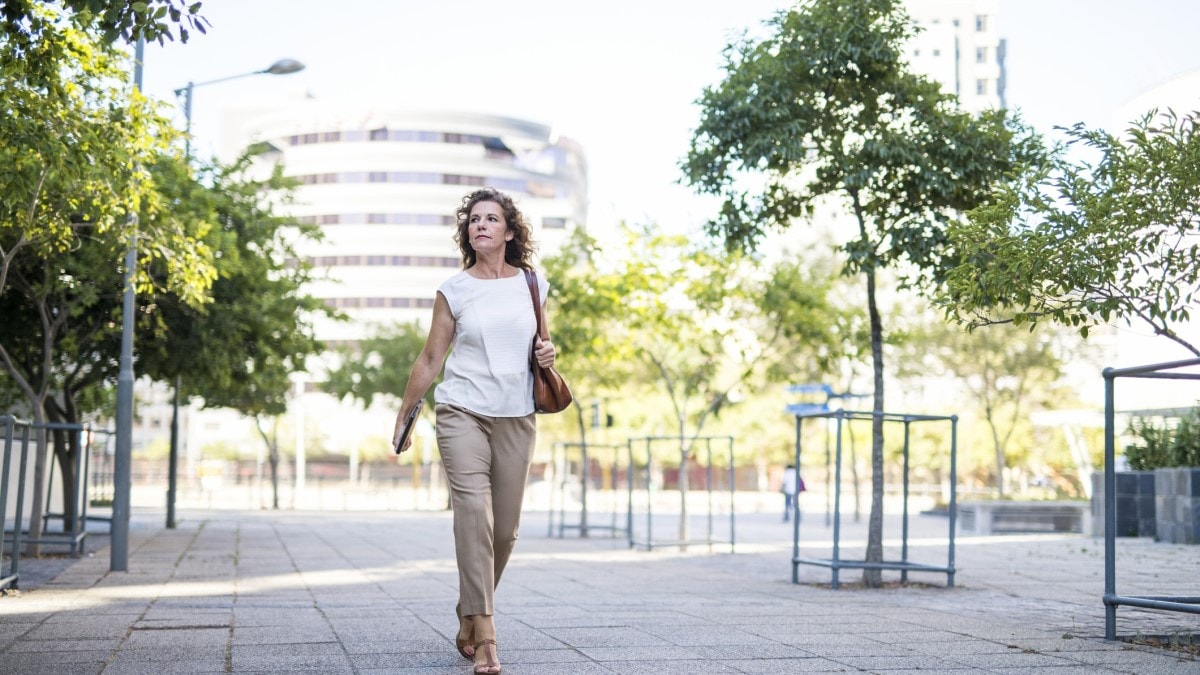 Photo of a woman walking down a street