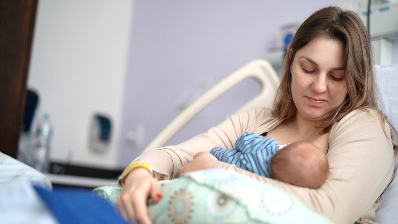 mPINC Tool Resources Woman breastfeeding a newborn baby in a hospital setting