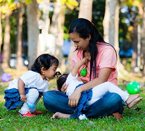 family-in-park_285px A mother breastfeeding.