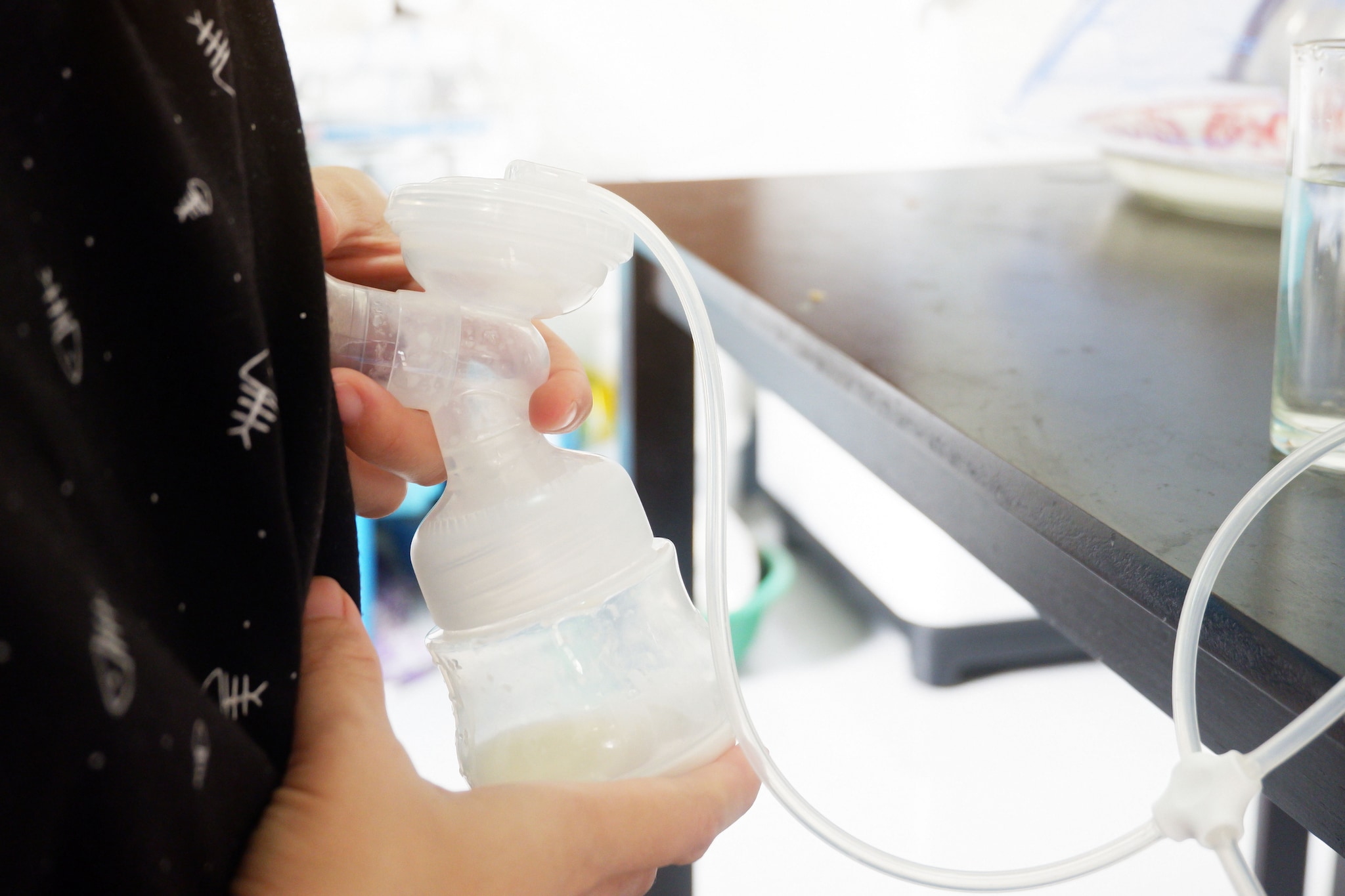 Female using breast pump A woman expressing breast milk using a breast pump