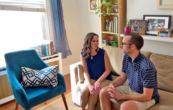 Cara and her husband sitting in their living room