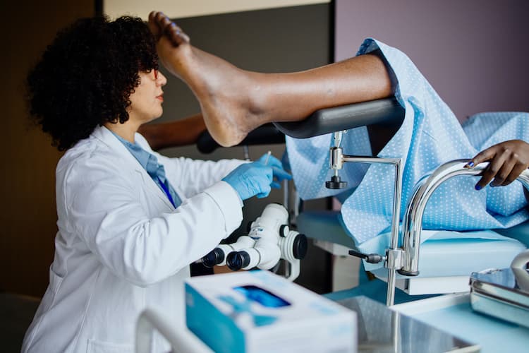 Photo of a gynecologist performing a Pap test.