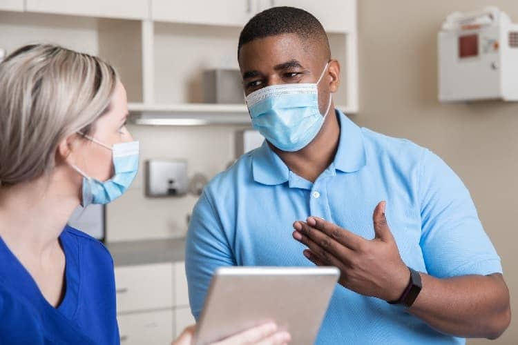 Photo of a woman asking her doctor a question