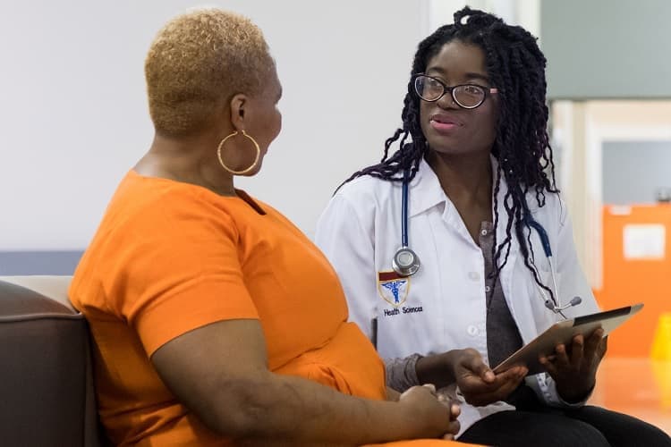 Photo of a patient talking to her doctor