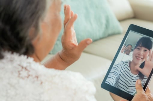 Photo of a woman making a video call from her home