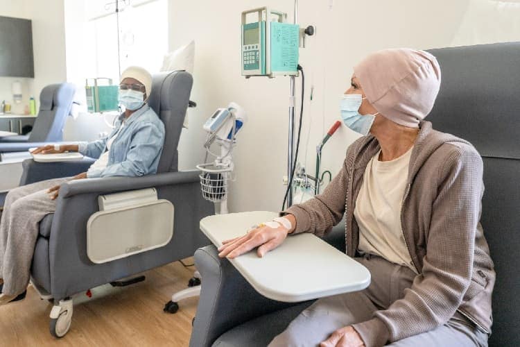 Photo of two women getting chemotherapy