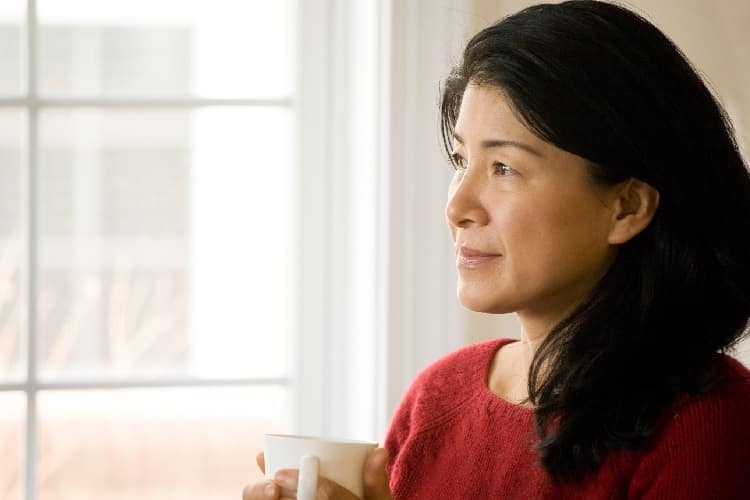 Photo of a woman drinking coffee