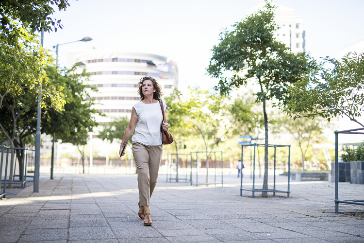 Photo of a woman walking down a street