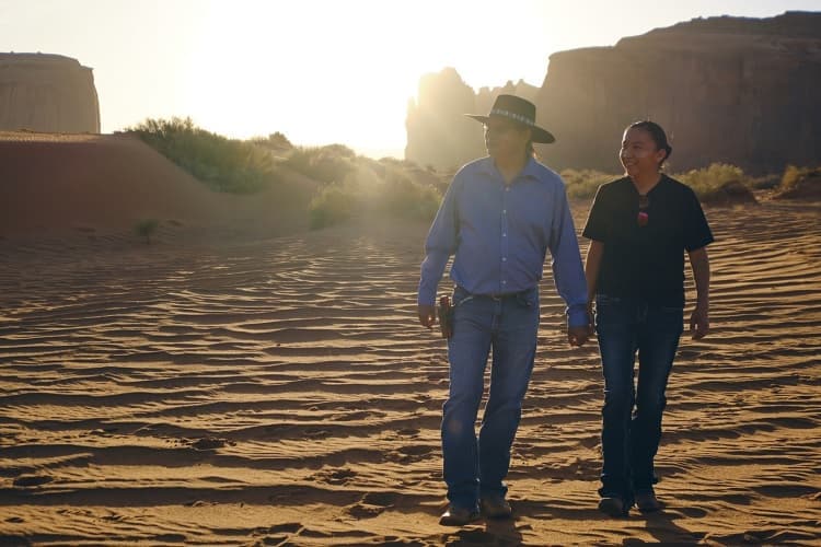 Photo of a Native American Navajo couple in the desert at Monument Valley