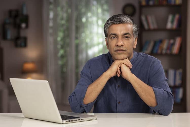 Photo of a man using a laptop computer