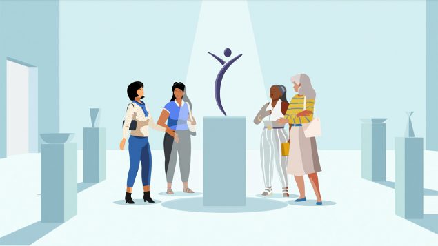 Image of four women looking at artwork shaped like the Inside Knowledge logo