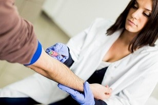 cholesterol-screening Man getting his blood drawn for a cholesterol screening test.