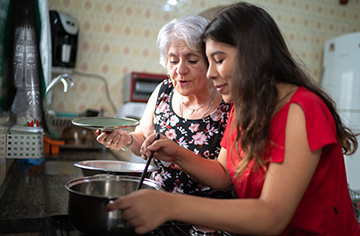 Grandmother Teaching Her Granddaughter How to Cook