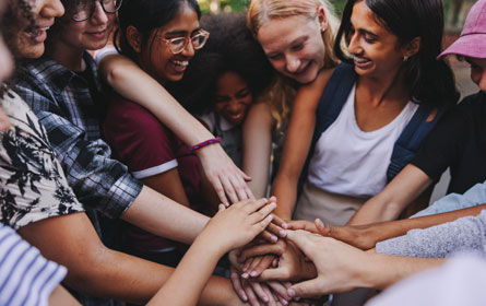 SDOHFurther Group of people in circle holding hands