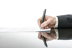 signature250X166.jpg Person signing contract with pen.