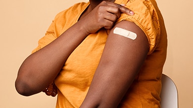 closeup-of-black-woman-arm-with-bandaid Closeup of black woman arm with bandaid.