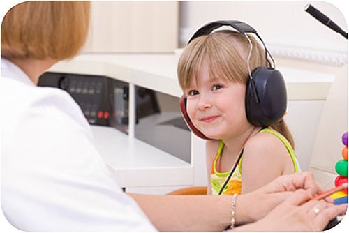 — title missing — Young child receiving hearing checks from doctor.
