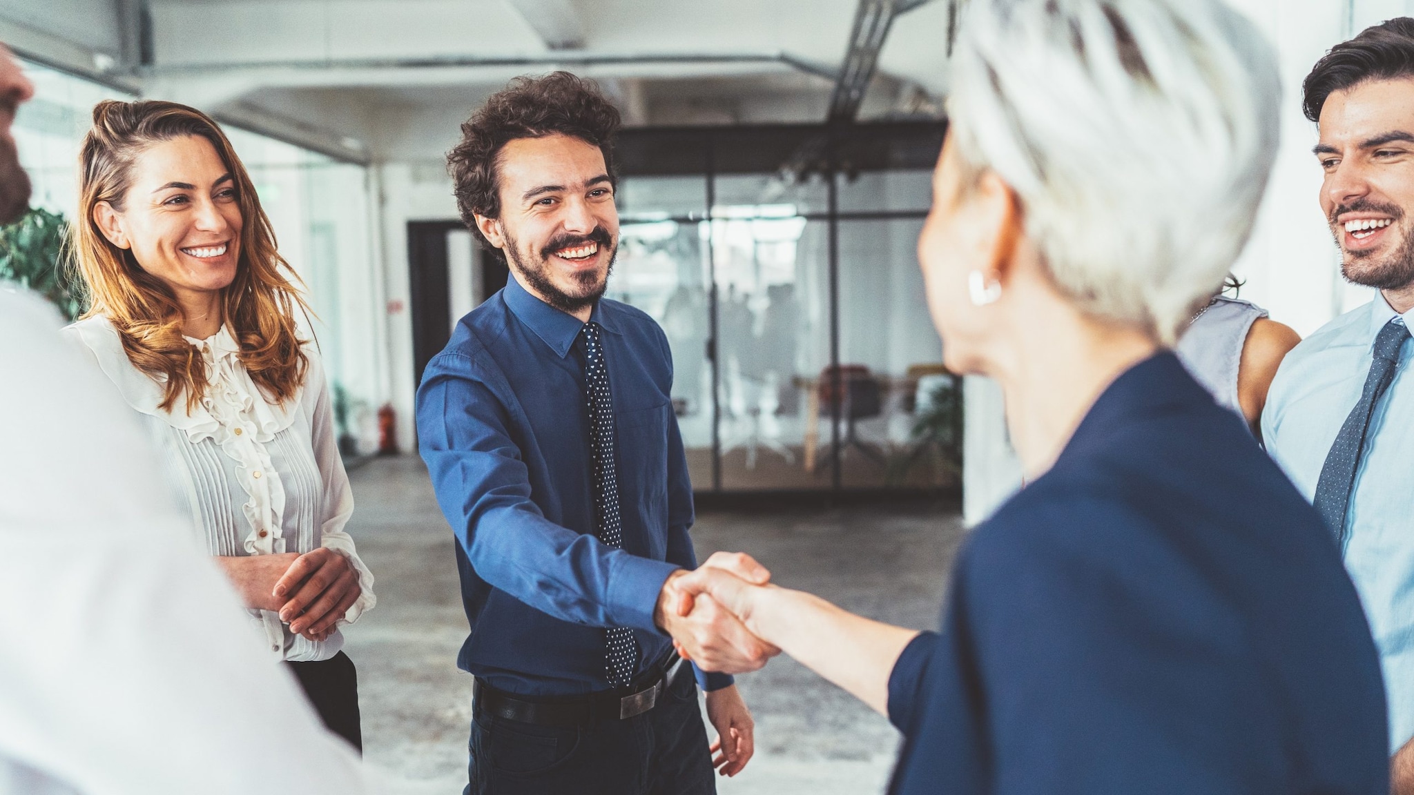 Businessman and woman shake hands A businessman and woman shake hands in an office setting.