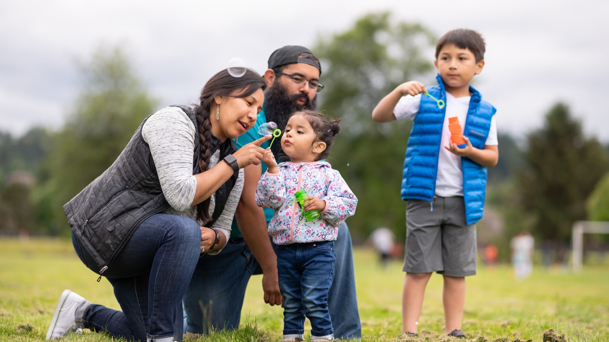 About NDWP Native American family blowing bubbles at a park