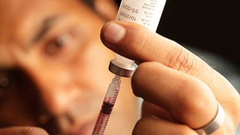 types-of-insulin2-cr Man filling a syringe with ins