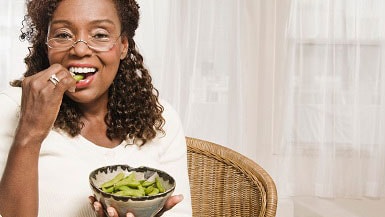 Woman eating edamame Woman eating edamame