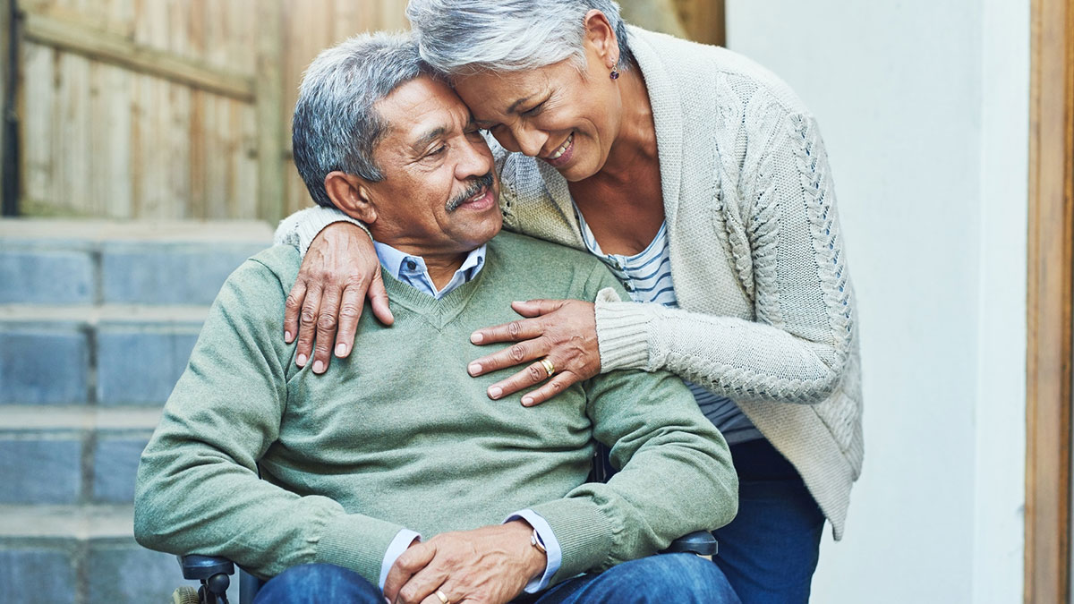 I'm so blessed to have you in my life Senior couple. Female hugging male on wheel chair