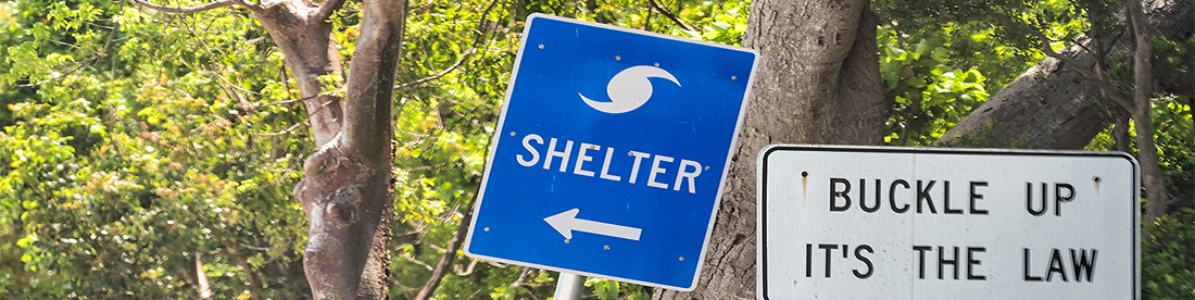 A road sign pointing the way to a hurricane shelter A road sign pointing the way to a hurricane shelter