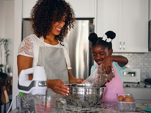 Mother and daughter preparing cupcakes