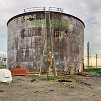 Patrick Dawson walking down building stairs of storage tank