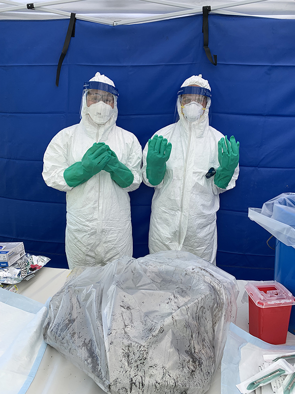 EIS officer Julia Petras (2021) and LLS fellow Maureen Ty (2021) obtain samples during a follow-up investigation.