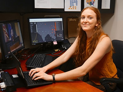 EEP student sitting at computer desk.