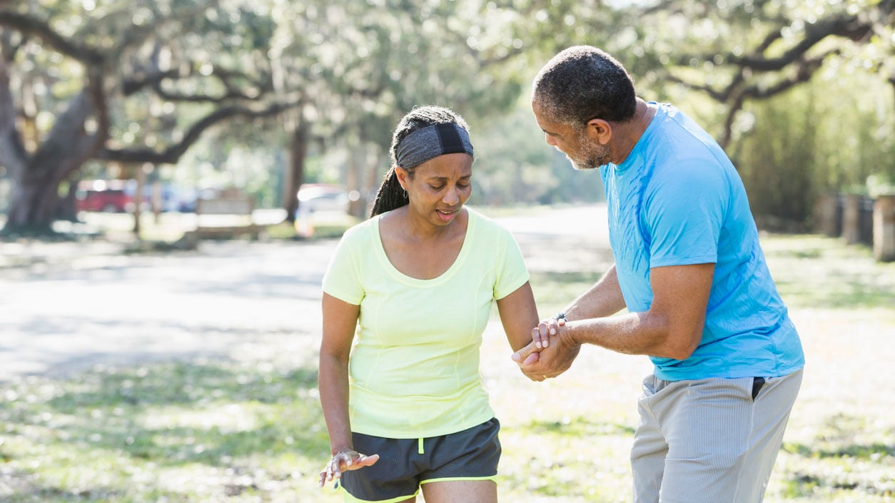 A man helping a woman walk safely on the street A man helping a woman walk safely on the street