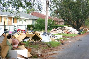 Casas tapiadas con garaje y escombros que bordean las calles.