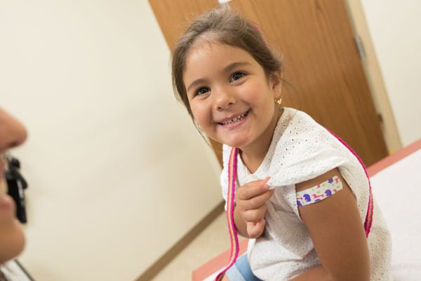 child-receiving-vaccination A smiling child who has just received a flu vaccine