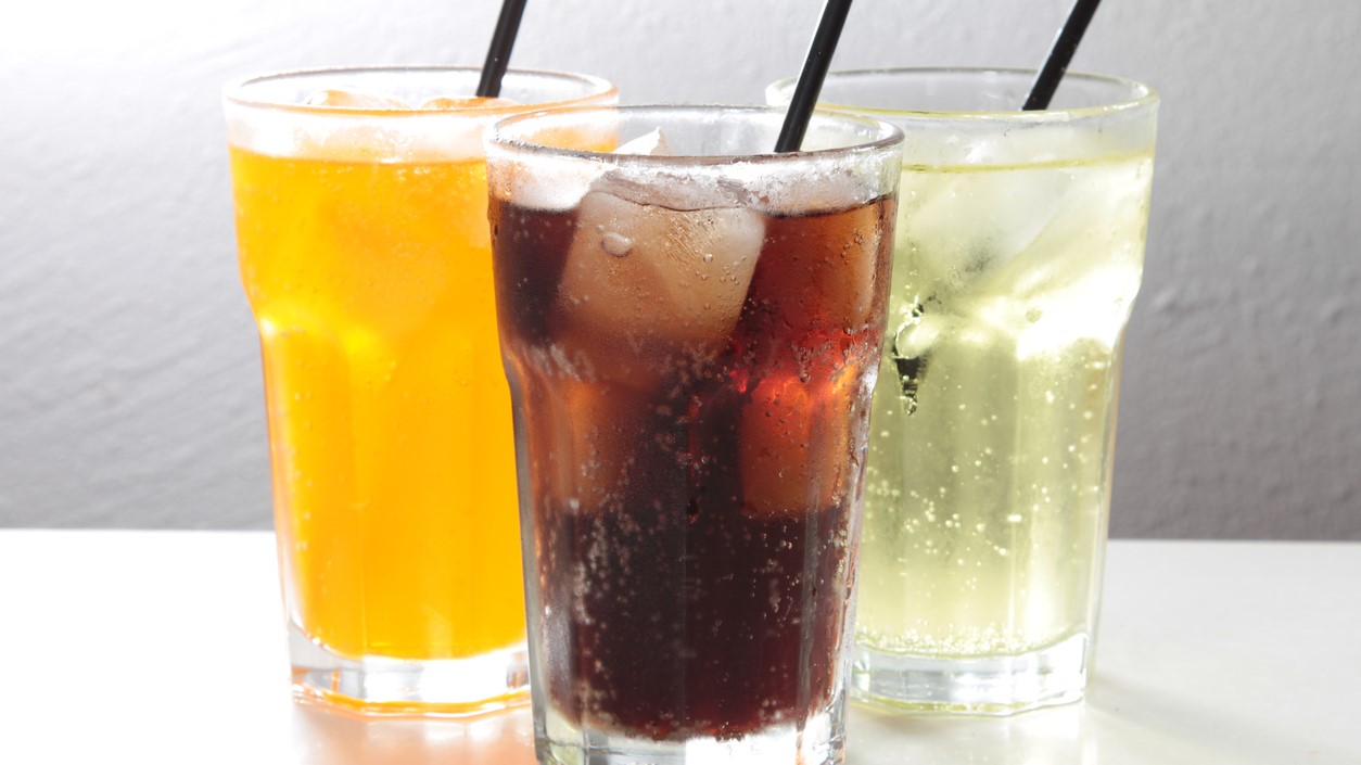 Three varieties of soft drinks in glasses.