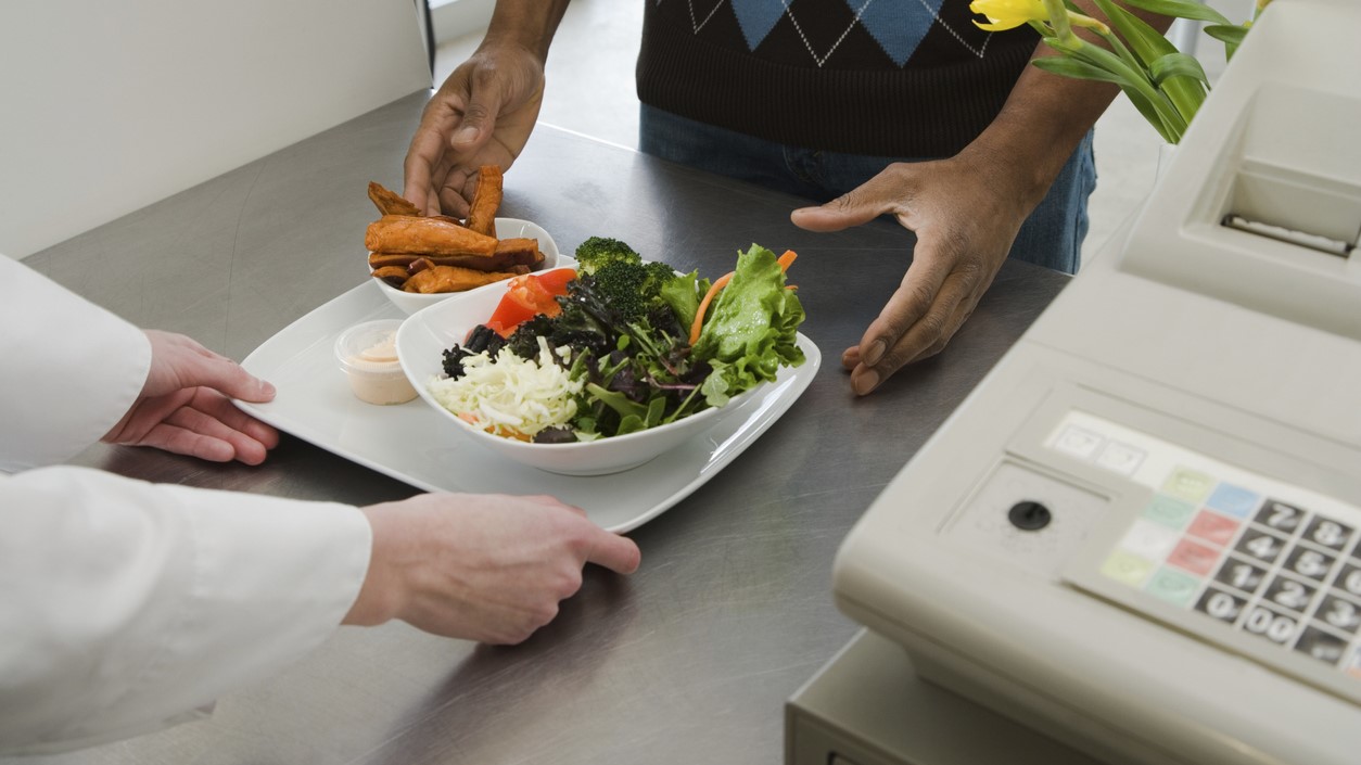 Man receiving meal at cash register.